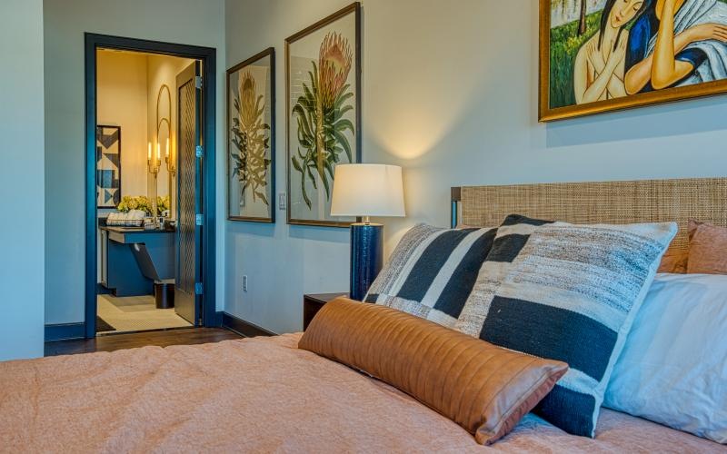 a bed with pictures on a wall