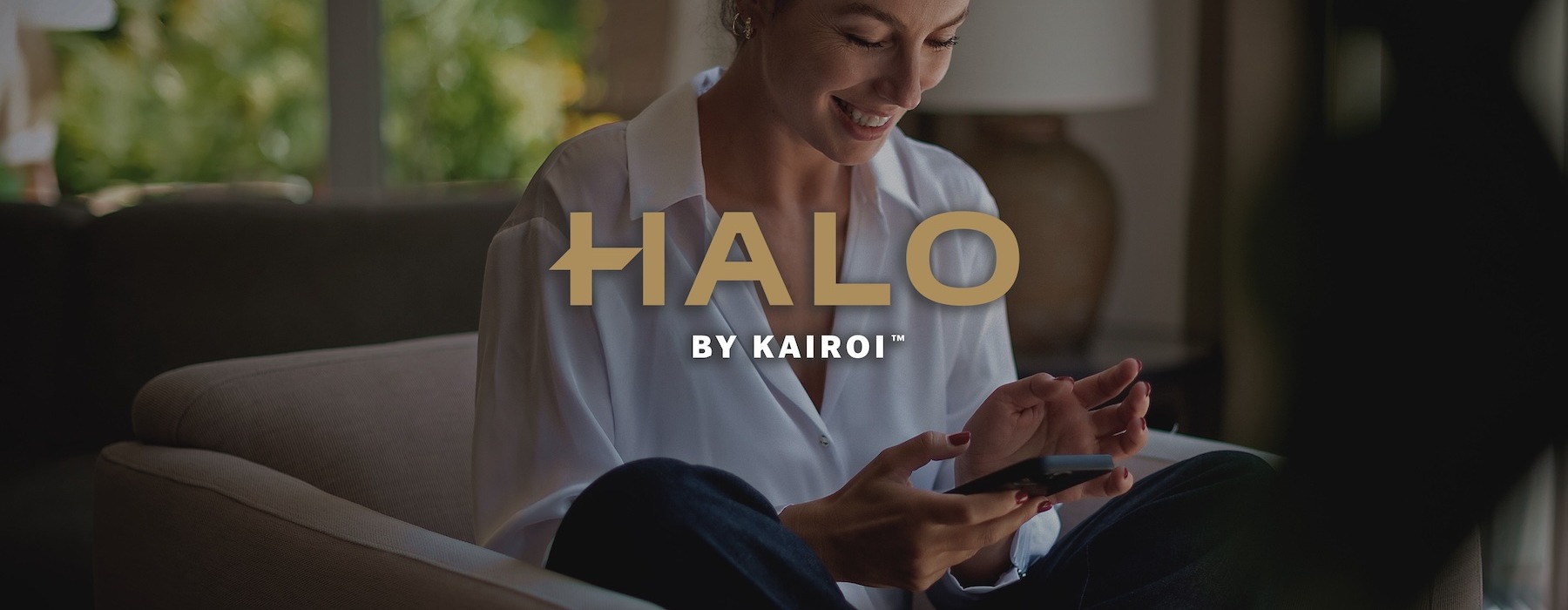 a woman smiling and interacting with her device